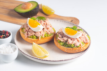 Two delicious tuna open sandwiches with avocado and boiled eggs. Tuna toast.