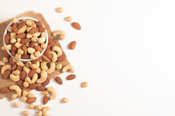 Large assortment of nuts in different bowls on stone table