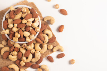 Large assortment of nuts in different bowls on stone table