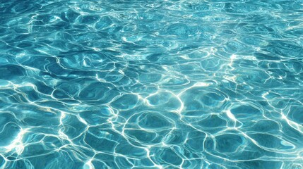 Obraz premium Sunlight dances on the surface of clear turquoise water showcasing beautiful patterns that inspire calm.