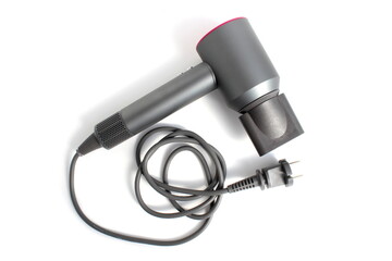 There is a gray hair dryer lying on a white background.	