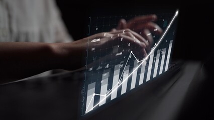 A pair of hands interacts with a virtual financial graph, showcasing an upward trend on a digital display, emphasizing modern analytics and growth. Copula