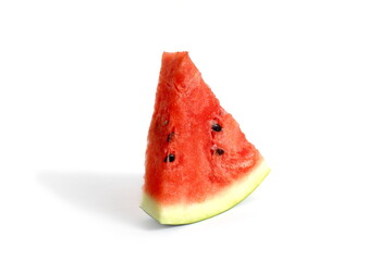 On a white background there is one triangle piece of watermelon.	