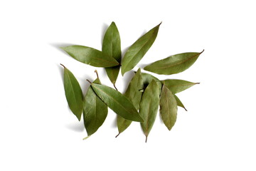 A small pile of bay leaves lies on a white background.	