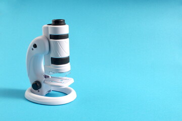 There is a toy microscope on a blue background.
