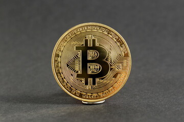 There is a souvenir bitcoin coin on a black background.	