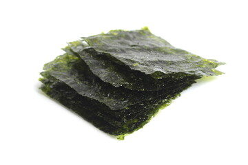 There are many nori sheets lying on a white background.	