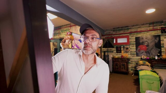 Focused male painter creating art in his studio