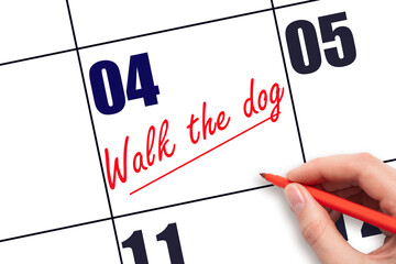 4 th day of the month.  Hand writing Walk the dog reminder and drawing a line on calendar with red...