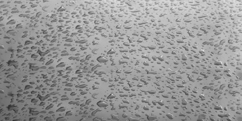 Water drops on a flat gray surface