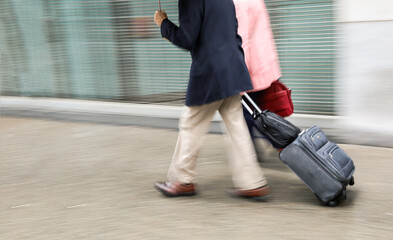 Blurred image of a man with a suitcase