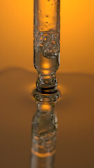 Close up view of Cosmetic oil with bubbles in pipette on bright background.