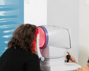 Doctor diagnoses eye diseases using modern ophthalmological equipment. Concepts of eye diseases, ophthalmology, vision health, vision diagnostics, medicine of the future.