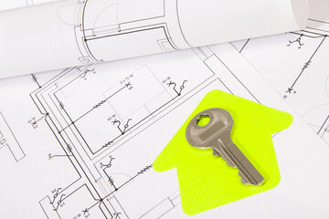 Construction drawing of electric installation, paper in shape of house and key. Building or buying of home