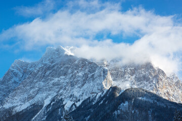 Panoramic view of beautiful winter mountain scenery in the Alps in sun light.