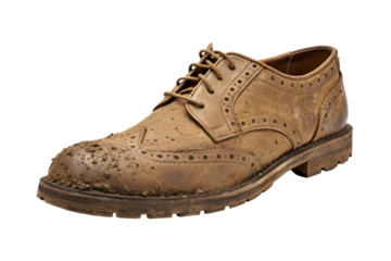 A close-up, full-frame studio shot of a single brown leather wingtip shoe splattered with mud, perfect for showcasing footwear durability and rugged style in advertising or fashion campaigns