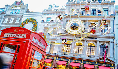 Obraz premium Christmas Decorations, Cartier Boutique Shop, Old Bond Street, Red Telephone Box, Festive Celebration, West End, Central London, England, UK - December 2024
