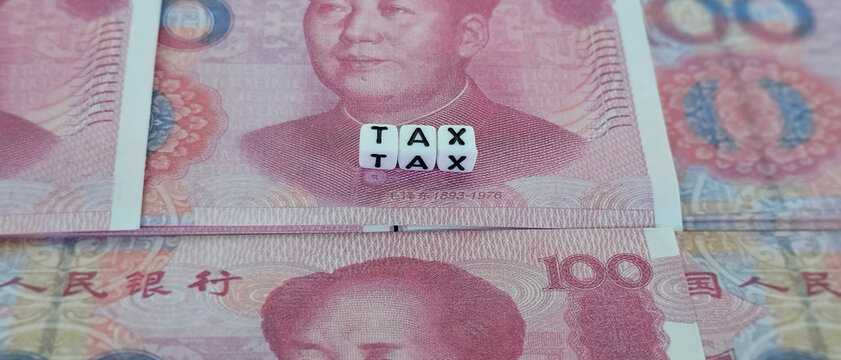 Yuan banknotes with stock market decreasing graph chart for  - Powered by Adobe