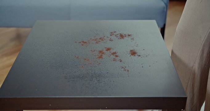 Satisfying process of cleaning a coffee spill off a dark table, with every spray and wipe captured in clear, immersive sound. This video highlights domestic chores and effective cleaning methods.