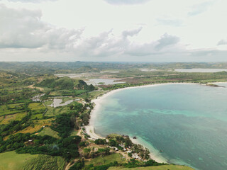 The coastal view is surrounded by enchanting green hills, including Merese Hill, which offers a spectacular viewpoint to enjoy the scenery. LOMBOK, NTB , INDONESIA