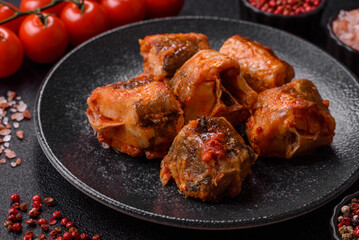 Hake fish cooked in pieces in tomato sauce, stew with peppers and carrots. Hake fish in tomato