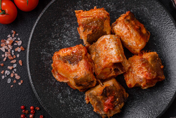 Hake fish cooked in pieces in tomato sauce, stew with peppers and carrots. Hake fish in tomato