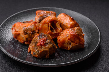 Hake fish cooked in pieces in tomato sauce, stew with peppers and carrots. Hake fish in tomato