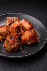 Hake fish cooked in pieces in tomato sauce, stew with peppers and carrots. Hake fish in tomato