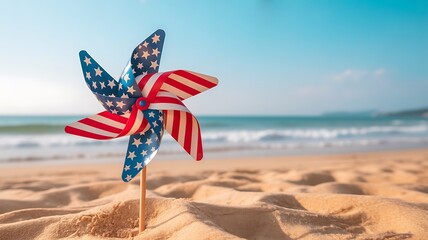 A pinwheel decorated with the american flag spins on a sandy beach, symbolizing patriotism and summer fun by the ocean