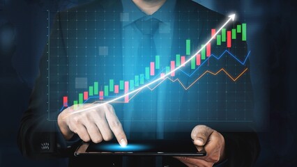 A business professional reviews financial data on a tablet, showing interactive charts and graphs that depict growing market trends and investment opportunities. Copula