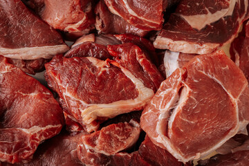 A close-up of raw, marbled beef cuts, showcasing rich red color and fat layers, ready for grilling...