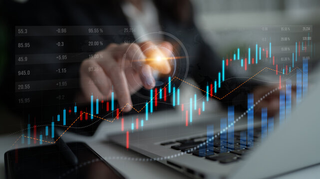 A professional analyzing stock market trends on a laptop, showcasing overlaid graphs and data visualization, represents modern finance and investment strategies. Scalp