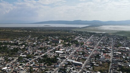 Laguna de Cuitzeo, Pueblo, carretera hacia Cuitzeo. Drone view: the vast contours of Laguna de Cuitzeo unfolding beneath the clouds
