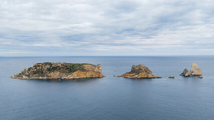 Medas Islands archipelago emerging from the deep blue Mediterranean Sea under a cloudy sky in Catalonia showcasing Spain's rugged coast and natural beauty