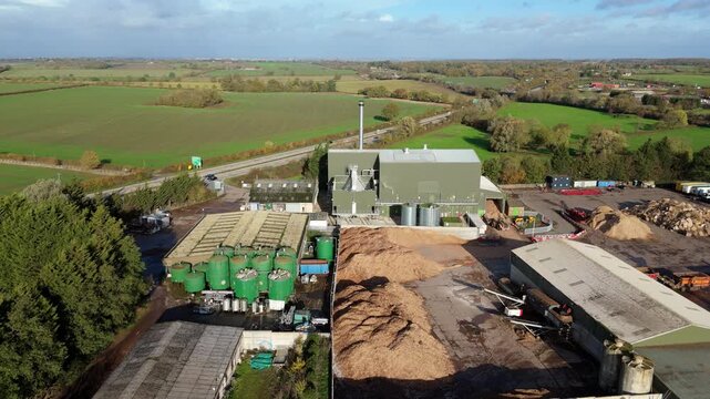 Aerial drone view of biomass power plant, renewable energy generation from waste organic material creating green electricity in rural landscape, Widmerpool, United Kingdom