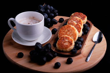 Breakfast with delicious cottage cheese pancakes with honey and a cup of coffee