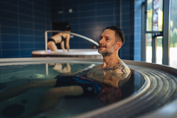 Man relaxing in hot tub enjoying spa wellness leisure