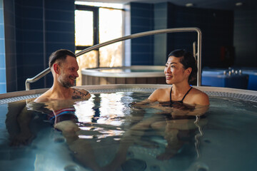 Couple enjoying spa hot tub wellness and relaxation