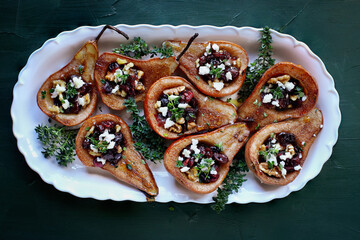 Baked pears. brushed with olive oil and seasoned with some cinnamon. Bake at 375f or 180c degrees for 25 minutes, removed from oven. Add feta cheese, cranberries, walnuts. Garnish with honey and thyme