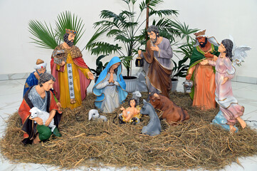 Traditional Christmas nativity scene represented with porcelain figurines of Mary, Joseph and baby Jesus.