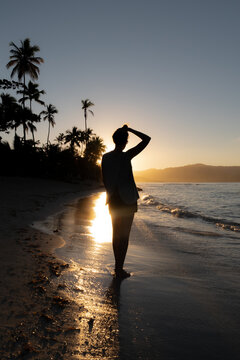 Woman on the beach at sunset in the town of Las Galeras in The Dominican Republic.