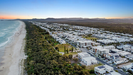 Sunset drone aerial view of beachfront properties at Salt Kingscliff overlooking coastline and ocean