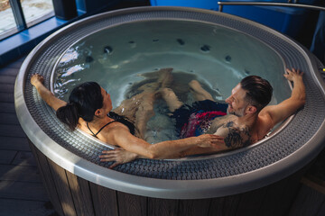 Couple relaxing in hot tub enjoying wellness spa