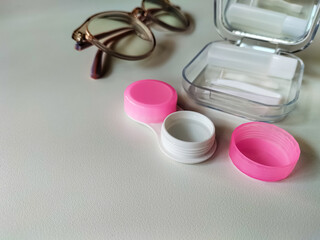 Contact lens kit on a neutral background. 