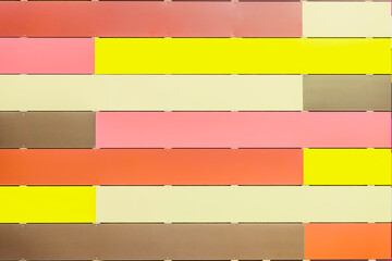 Colorful wall with Horizontal soft pastel panels in pink, yellow, cream, and brown, tender striped background. Abstract minimalism, light backdrop design, copy space