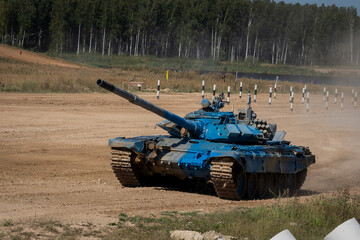 Fototapeta premium Blue Tank in Motion on Training Terrain