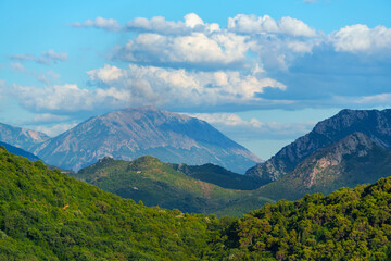 beautiful landscape with a view of the mountains covered with forest on a bright sunny day