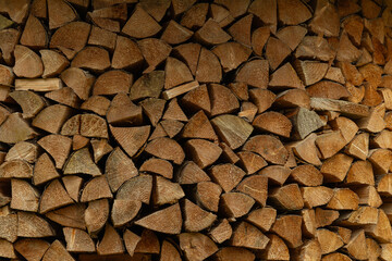 Woodpile of split logs full frame background
