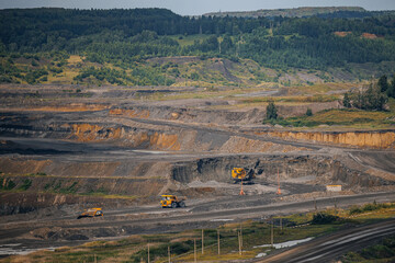 Expansive open pit coal mine excavation landscape with heavy machinery operations