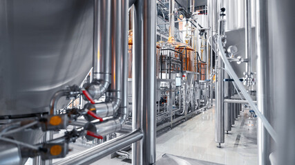 Modern industrial brewery factory with stainless steel equipment and storage tanks